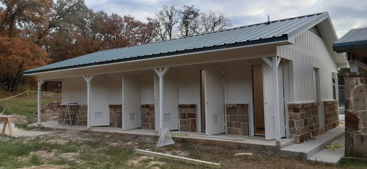 New white porch with stone columns on a country home